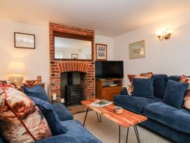 A living room with a sofa and coffee table at Cobblers Cottage in Southwold