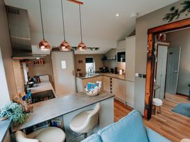 A kitchen with a stove and refrigerator at TyCosy St Davids