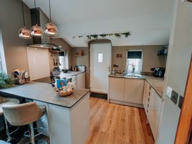 A kitchen with a countertop, sink, and cooking utensils at TyCosy in St Davids