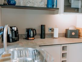 A kitchen countertop with appliances and storage at TyCosy St Davids
