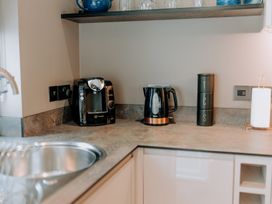 A kitchen with coffee machine and kettle at TyCosy St Davids