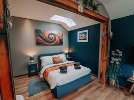 A bedroom with a bed and nightstands at TyCosy St Davids