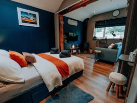 A bedroom with a bed and a sofa at TyCosy St Davids