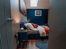 A bedroom with a bed and bedside table at TyCosy in St Davids
