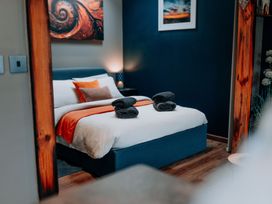 A bedroom with a bed and towels at TyCosy in St Davids