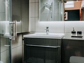 A bathroom with a sink and mirror at TyCosy in St Davids