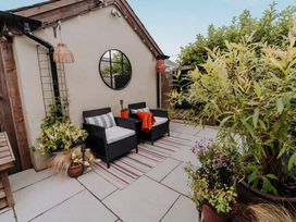 An outdoor seating area with chairs and a table at TyCosy St Davids