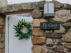 An outdoor entrance with a stone wall and gate at Ty Cosy in St Davids