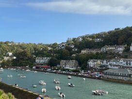 A view of boats on the water with houses on the hillside at Rivercrest in Looe