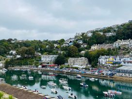 A view of a harbor with boats and houses in Looe at Rivercrest