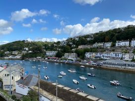 A view of a marina with boats and houses at Nesden House 
