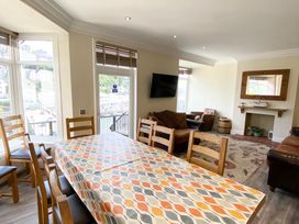 A dining room with a table and chairs at Nesden House 