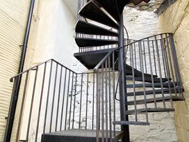 A spiral staircase in an interior space at Nesden House