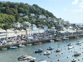 A harbor with boats and colorful houses at Nesden House 
