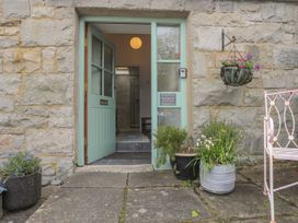 An entrance with a front door and planters at Riverside Cottage in Caernarfon