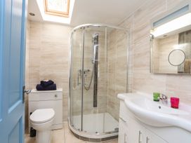 A bathroom with a shower and sink at Riverside Cottage in Caernarfon