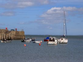 A view of boats at a pier on water at Riverside Cottage in Caernarfon