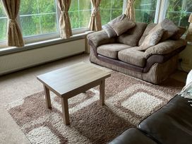 A living room with a sofa and coffee table at Windy Ridge in Penzance