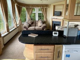A snug with a couch and television at Windy Ridge in Penzance