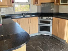 A kitchen with a sink and stove at Windy Ridge in Penzance