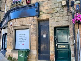 A bank exterior with a sign and door at Downton II Alnwick