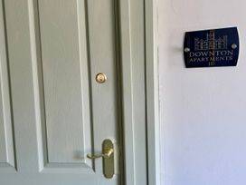 A door with a nameplate indicating Downton Apartments II in Alnwick