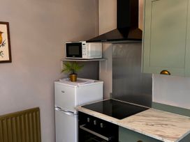 A kitchen with a refrigerator and microwave at Downton II in Alnwick