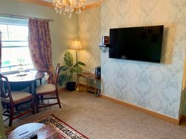 A living room with a table and chairs at Downton II in Alnwick