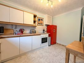 A kitchen with cabinets and a red refrigerator at No 1 The Martins Walberswick
