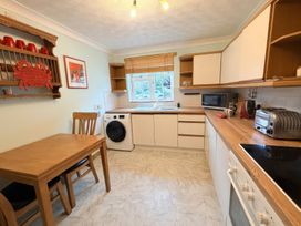 A kitchen with a table and chairs at No 1 The Martins in Walberswick