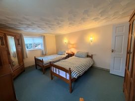 A bedroom with twin beds and a wardrobe at No 1 The Martins Walberswick