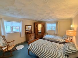 A bedroom with two beds and a dresser at No 1 The Martins in Walberswick