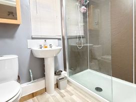 A bathroom with a toilet sink and shower at No 1 The Martins Walberswick