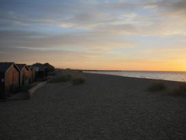 Beach huts along the shore during sunset at No 1 The Martins Walberswick
