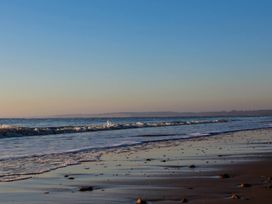 A beach scene with waves and sand at No 1 The Martins Walberswick