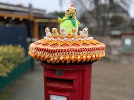 A post box with a crochet cover featuring birds at No 1 The Martins Walberswick