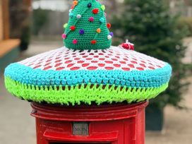 A decorated post box with a knitted cover at No 1 The Martins Walberswick