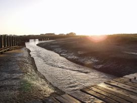 A waterway leading to a pier at No 1 The Martins Walberswick