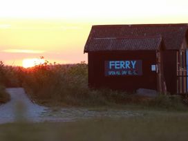 A ferry building with a sign and pathway at No 1 The Martins in Walberswick