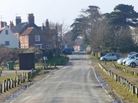 A view of a residential street with houses and parked cars at No 1 The Martins Walberswick