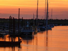 Boats docked at a pier during sunset at No 1 The Martins Walberswick