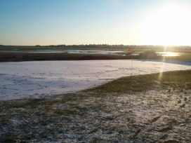 A golf course putting green with a flag at No 1 The Martins Walberswick