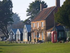 A house and telephone box in an outdoor area at No 1 The Martins Walberswick