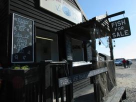 A fish shop with a sign for fresh fish for sale at No 1 The Martins Walberswick