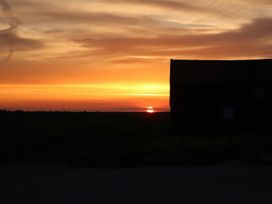 A sunset behind a building at No 1 The Martins Walberswick