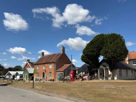 A street view with a house and bicycles at No 1 The Martins Walberswick