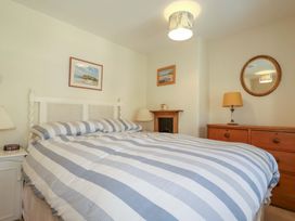 A bedroom with a bed and lamp at Mary’s House