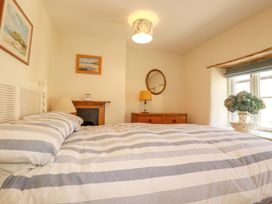 A bedroom with a bed and chest of drawers at Mary’s House