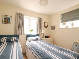 A bedroom with two beds and a window at Mary’s House