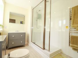 A bathroom with a shower and sink at Mary’s House